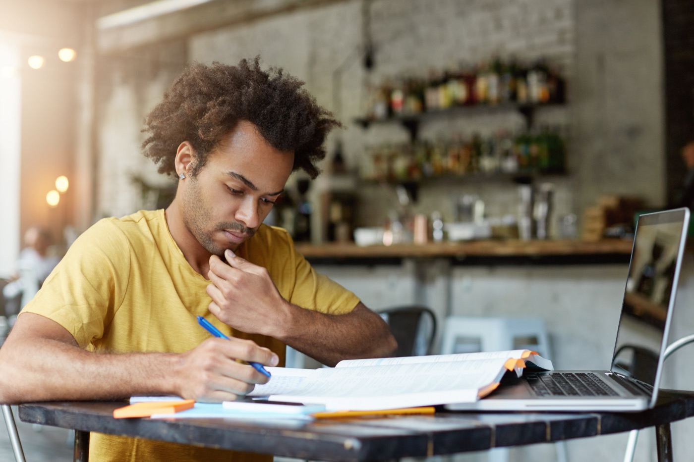 A student concentrating on handwritten study notes